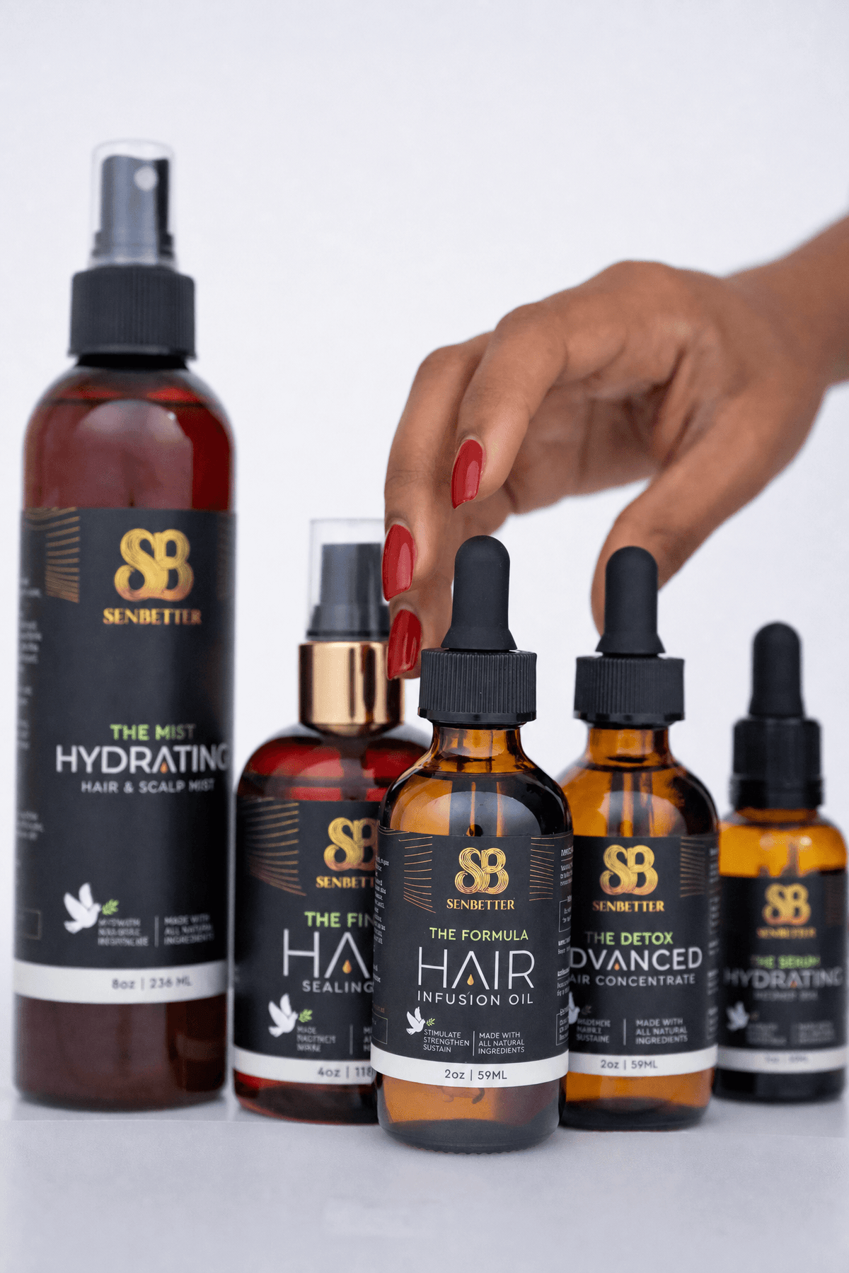 Female hand reaching for Senbetter botanical hair oil products