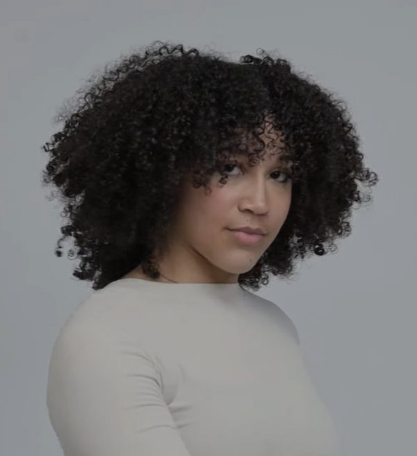 Curly hair hydrated and defined after using The Mist hair spray