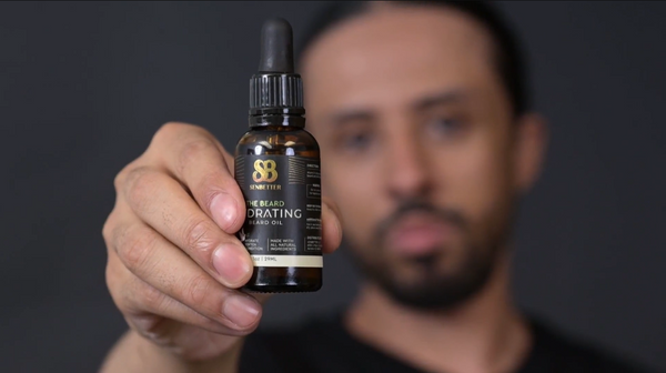 Bearded man holding The Beard botanical beard oil for men