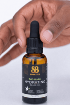 Hand holding The Beard botanical beard oil bottle with dropper