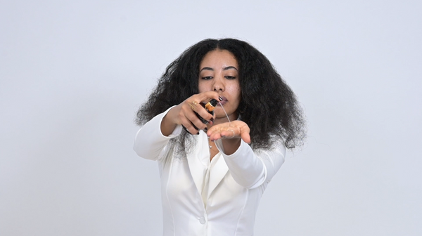 Curly hair with smooth, shiny finish after using The Finish sealing oil